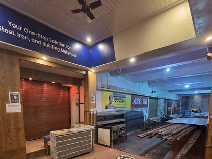 The counter inside Jay Shree Infra, star medallions in the floor, an UltraTech and ACC board on the far wall